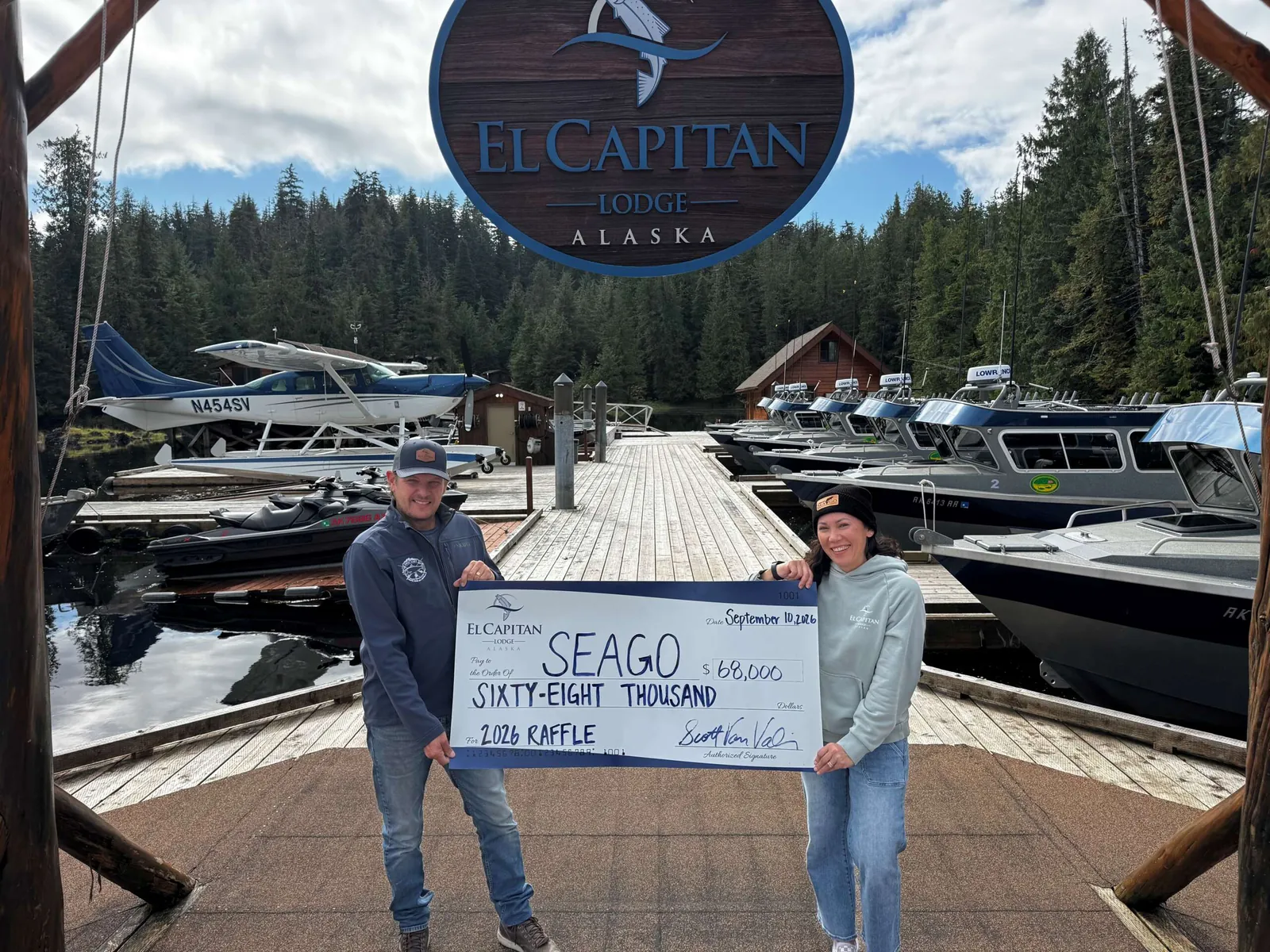 El Capitan Lodge presenting a $68,000 cheque to SEAGO from the 2026 raffle, on the lodge dock